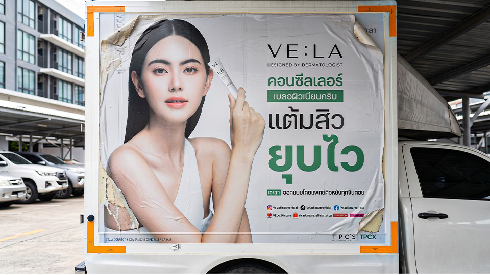 สติ๊กเกอร์โฆษณาบนตู้บรรทุกสินค้ามีอาการหดตัวและขอบลอกร่อนทุกมุม จำเป็นต้องรื้อสติ๊กเกอร์เก่าและติดตั้งใหม่แทนการติดทับ