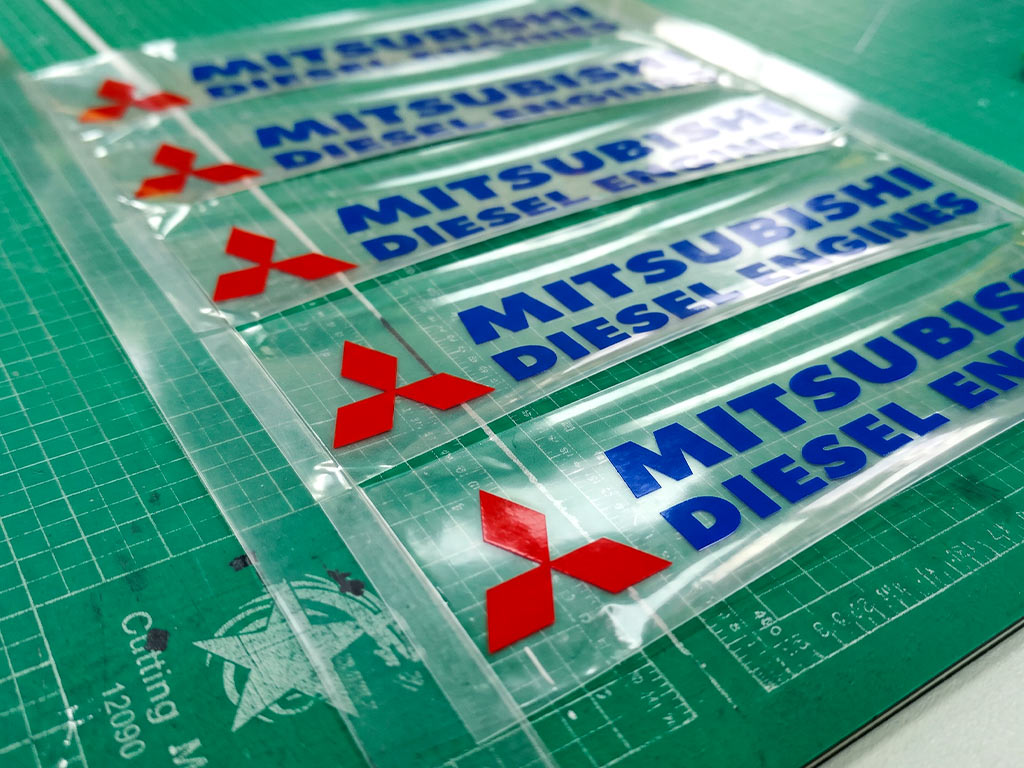 ชุดสติ๊กเกอร์ทนความร้อน Mitsubishi Diesel Engines จัดเรียงบนแผ่นรองตัดงานพิมพ์ระบบดิจิตอล