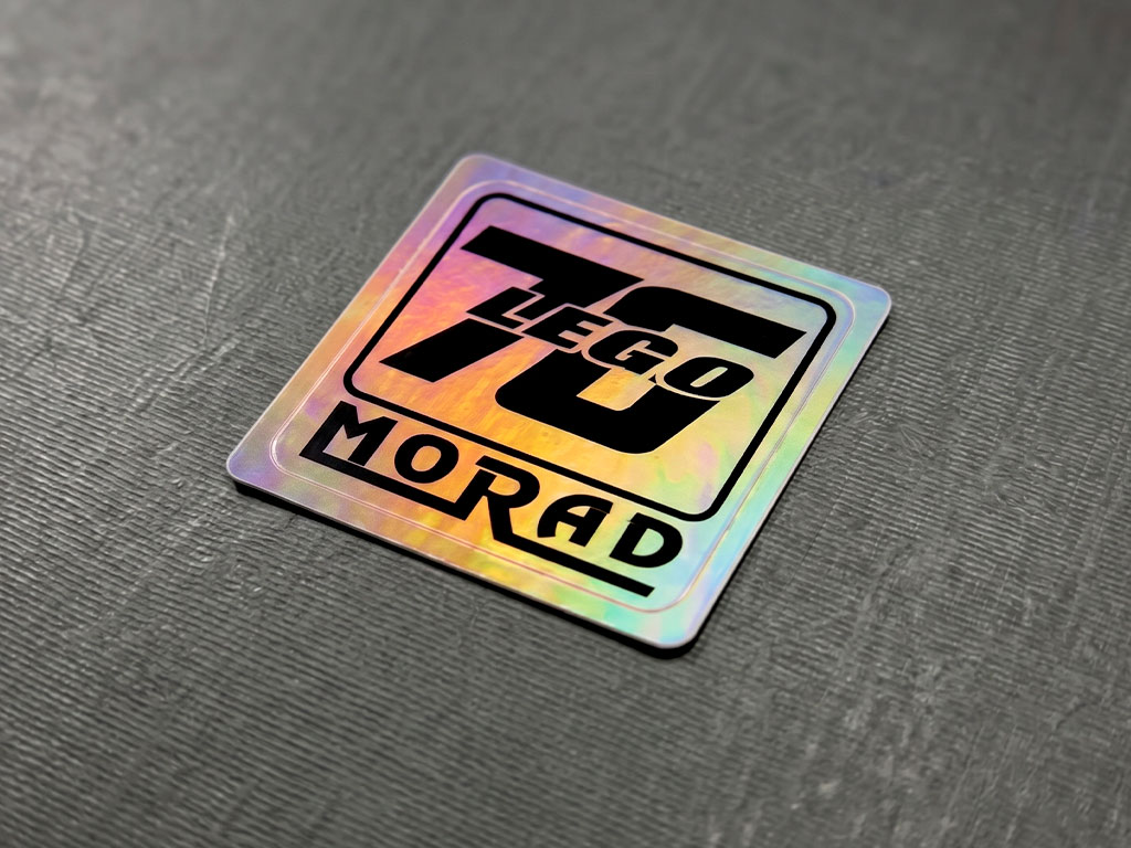 สติกเกอร์แสดงร่องรอยเมื่อเปิด กันปลอม ดวงเดี่ยว 76 LEGO MORAD ขอบมนเงางามบนพื้นผิวขัดลาย